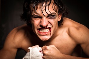 Young athletic male street fighter, against black background